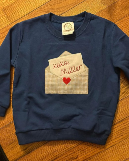 Appliqued envelope with a fabric heart on a sweatshirt