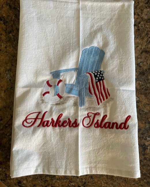Flour sack towel with an Adirondack chair, flag, and place name